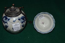 A small Chinese tea bowl and a Chinese blue and white porcelain and metal mounted flask.