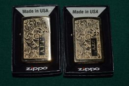 Two Zippo lighters.