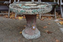 A reconstituted stone garden table.