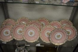 A set of twelve Copeland Spode 'Regent' plates, pink ground with central floral panels.
