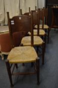 William Birch, a set of four oak framed rush seated dining chairs.