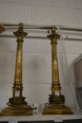 A pair of brass corinthian column table lamps.