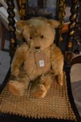 A well loved teddy bear, possibly a Chiltern Hugmee or a Farnell.