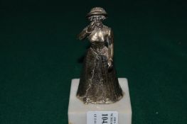 Cast metal figure of a women on a marble base.