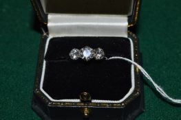 A platinum and diamond three stone ring, the central stone approx 1ct, flanked by two stones each