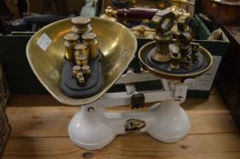 Weighing scales and two sets of weights.