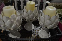 A set of three artichoke style candle holders.