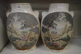 A pair of Continental porcelain vases, each painted with panels of landscapes.