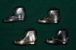 Four boot shaped pin cushions.
