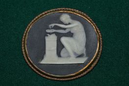 A yellow metal and jasperware classical style oval shaped brooch.