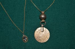 A coin necklace and amethyst necklace.