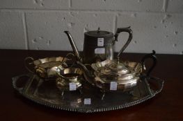 Plated twin handle tray, three piece plated tea service and a coffee pot.