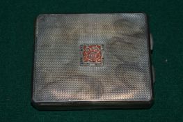 A combination silver compact and cigarette case.