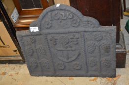 A cast iron fireback.