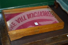 A small oak framed tabletop display case.