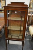 An Edwardian inlaid mahogany display cabinet.