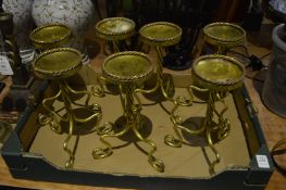 A set of seven gilt metal candle stands.