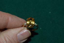 A gilded silver ring set with an oval cut citrine, with certificate.