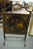 A chinoiserie decorated black lacquer fire screen.