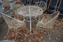 A white painted wire work patio set comprising, circular table and four armchairs.