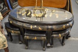 A Chinese black lacquer oval coffee table with chinoiserie decoration and matching small under