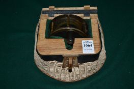 An old fishing reel engraved Macleay, housed in a creel style holder.