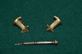A pair of Columbian style cufflinks and another item.