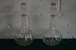 A pair of cut glass sherry decanters.