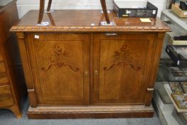A Continental style marquetry inlaid mahogany two door sideboard with drawers to the interior.