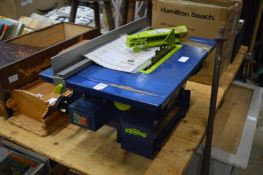 An electric tabletop circular saw.