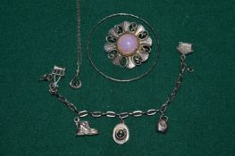A bangle, bracelet, chain pendant and brooch.