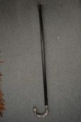 A walking stick with chrome plated handle.