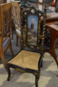 A Victorian black lacquer mother of pearl and gilt decorated occasional chair with painted back