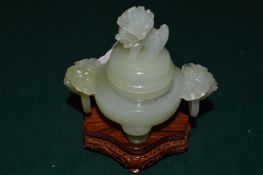 A Chinese carved jadeite koro and cover with hardwood stand.