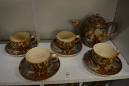 Japanese Satsuma part tea service comprising, teapot, four cups and saucers.