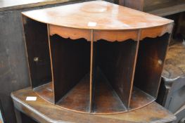 A mahogany corner shelf or storage unit.