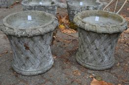 A pair of basket weave design reconstituted stone garden planters.