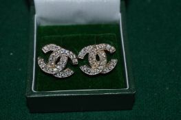 A pair of decorative earrings.