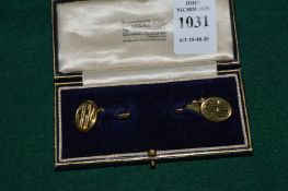 A pair of 18ct gold oval cufflinks engraved with initials.