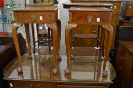A pair of walnut bedside tables on cabriole legs.