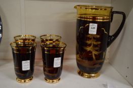 A cut glass and gilt decorated lemonade set comprising of jug and four tumblers.