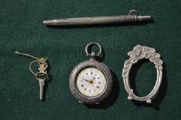 A silver watch, miniature frame and pencil.