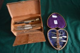 A heart shaped leather manicure case containing various items together with another leather case