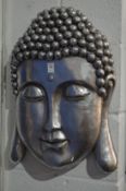 A large silvered resin Buddha's head wall plaque.