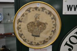 A pair of circular silk work pictures.
