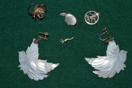 A flower head ring, locket, two pendants and a pair of decorative earrings.