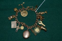 A 15ct gold curb link bracelet mounted with various 9ct gold and other charms.