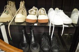 Five pairs of ladies training shoes, boots etc by Levis, CAT etc.