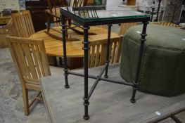 Oka, a plate glass and wrought iron lamp table.