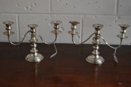 A pair of plated twin branch three light candelabra.